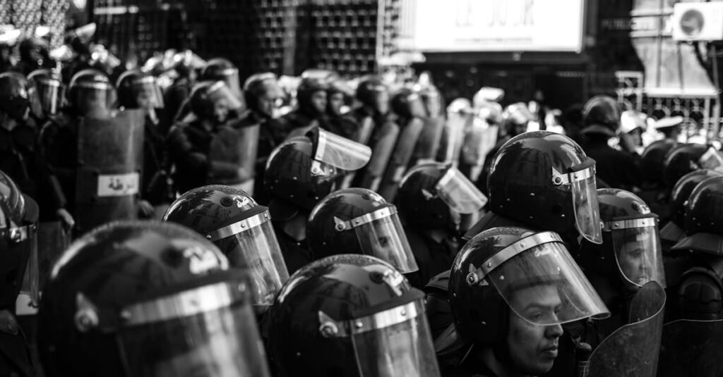 pexels-photo-4646677-4646677 Monochrome photo of Algerian police in riot gear at a protest.
